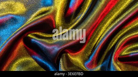 Shimmering colorful metallic fabric creating abstract waves and elegant drapery Stock Photo
