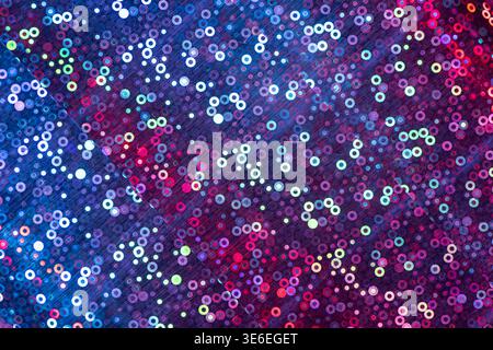 Holographic surface reflecting vibrant blue and purple light with glittering circles and dots Stock Photo