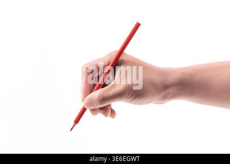 Hand holding a red colored pencil, ready for writing or drawing on a blank background Stock Photo