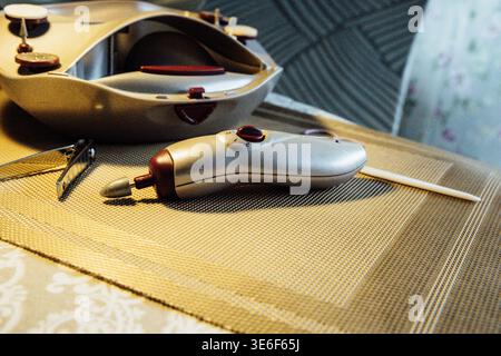Device on table ready for use in sewing project Stock Photo