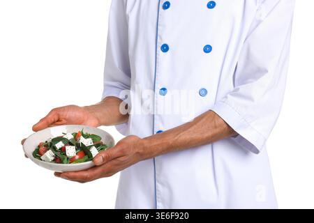 Professional chef with tasty salad on white background, closeup Stock Photo