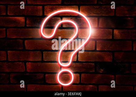 One neon question mark on brick wall Stock Photo