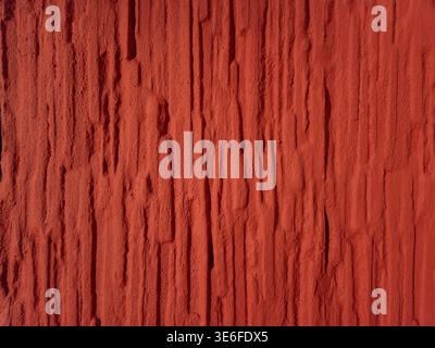 High resolution red textured wall background with rough vertical structure. Abstract surface suitable for design, backgrounds and creative projects. Stock Photo