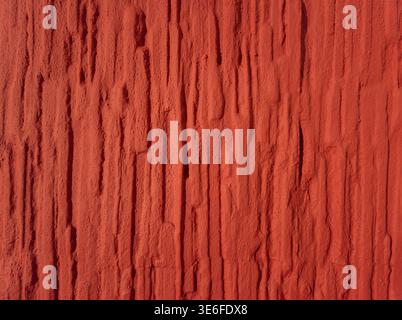 High resolution red textured wall background with rough vertical structure. Abstract surface suitable for design, backgrounds and creative projects. Stock Photo