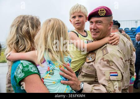 A Dutch, Military Captain and Officer being reunited with his family, his wife, his son and his daughter, after a Mission in Afghanistan on Airbase / Airforce Welschap Eindhoven, Netherlands. Stock Photo