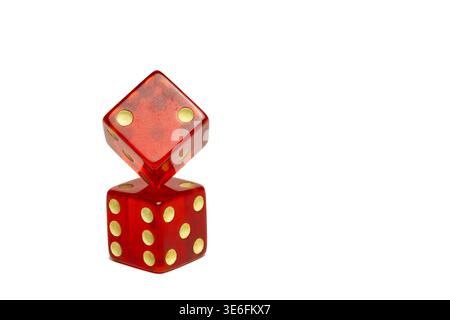 Red dice with one balanced on the other. Stock Photo