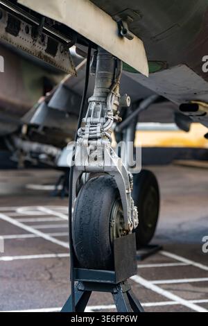 Close-Up Of Airplane Landing Gear And Nose Wheel Tire During Ground Maintenance At Airport Stock Photo