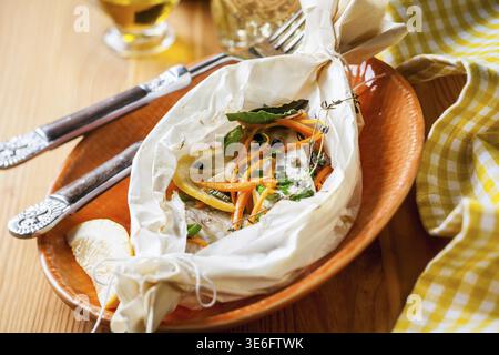 Cod fillets baked in parchment paper Stock Photo