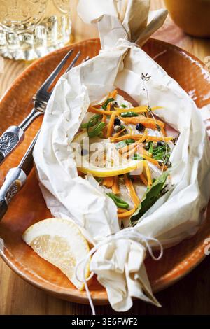 Cod fillets baked in parchment paper Stock Photo