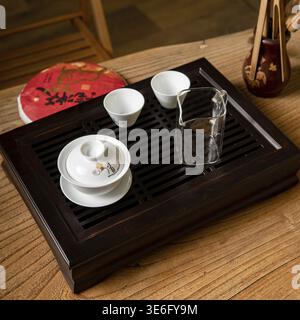 An elegant tea set beautifully arranged on a wooden tray, ideal for cherished tea ceremonies and social gatherings Stock Photo