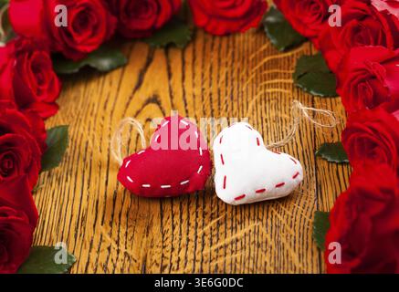 Two hearts with red roses on the wooden background Stock Photo