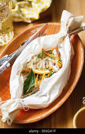 Cod fillets baked in parchment paper Stock Photo