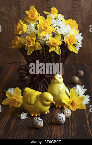 Easter table decoration with fresh daffodils, chick and eggs Stock Photo