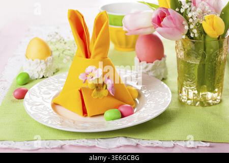 Festive table setting with Easter bunny napkin Stock Photo