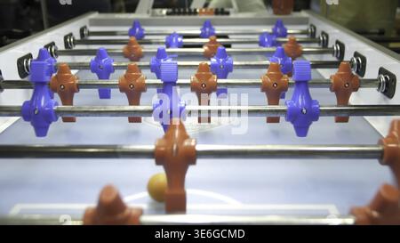 Table soccer. Foosball. Invisible playing table football. Unknown playing foosball. The table game players. The figures for the game of table football Stock Photo