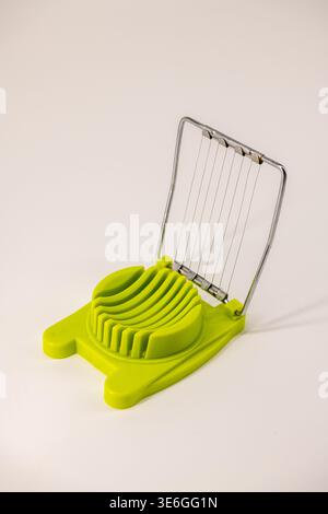Egg slice or Egg cutter for cutting boiled eggs isolated on white background. Selective focus. Stock Photo