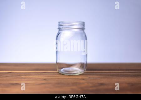 Empty Glass Jar on Wooden Surface with Copy Space Stock Photo