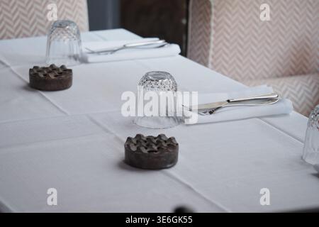 Table setup with glasses and utensils in an indoor space Stock Photo
