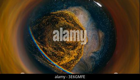 Blur golden splash. Light rainbow. Defocused bright yellow blue neon color ink glitter particles spatter circling on abstract background. Stock Photo