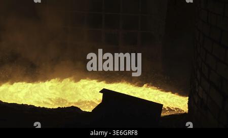 Liquid metal from blast furnace. Liquid metal pouring stream Stock Photo