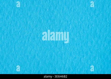 Bright cyan textured paper background with soft organic grain Stock Photo