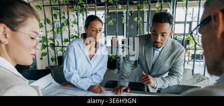 Engineers using tools to verify schematic accuracy and measurements Stock Photo