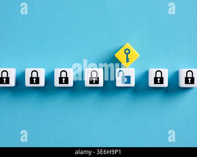 White blocks showing black closed padlocks with one open padlock with a yellow key on top symbolizing cybersecurity and data protection Stock Photo
