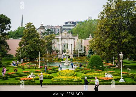 ISTANBUL, TURKEY.  25th May 2025. Tourists exploring the beautifully landscaped gardens of Dolmabahce Palace. The scene features a white ornamental fo Stock Photo