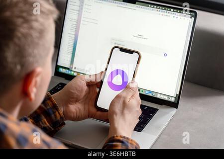 A man holds a smartphone with the Yandex Alice AI app. Saint Petersburg, Russia - 7 Apr 2026 Stock Photo