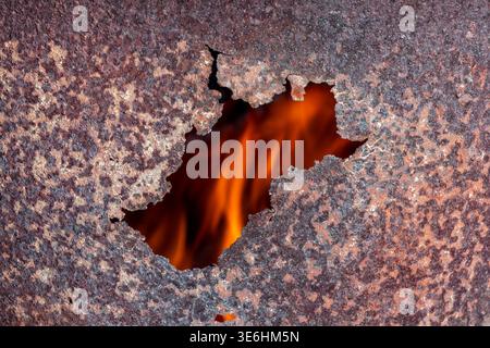 Rusty iron barrel for burning garbage on a farm. The fire burns inside the barrel. Farming and gardening. Stock Photo