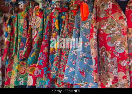 Vibrant traditional Chinese quilted floral jackets known as Dong Bei Da Hua on display in Dali Market, Yunnan, China on October 20, 2017. Stock Photo