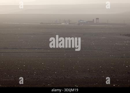 The desert outside Boumalne Dades, Morocco. The small white specs are pieces of plastic trash blowing across the desert from a nearby landfill Stock Photo