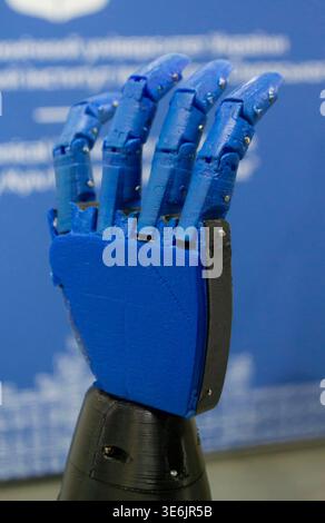 A functional 3D-printed robotic prosthetic hand. Object printed on 3D printer from melted plastic. Model palm with fingers created on 3D printer from threads of molten plastic. Medicine technologies Stock Photo