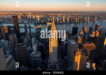 Elevated view of Midtown Manhattan skyscrapers and Art Deco landmark at sunset with Queens and Long Island City. New York City skyline, USA Stock Photo