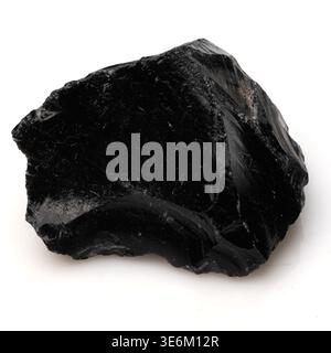 A high resolution close up of a natural black obsidian crystal showcasing its glossy texture and edges Stock Photo
