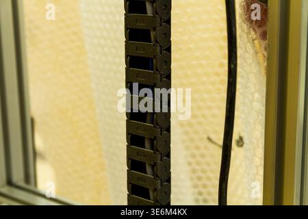 This item is a vertical cable management tray used to organize and protect cables in server racks or machinery. Stock Photo