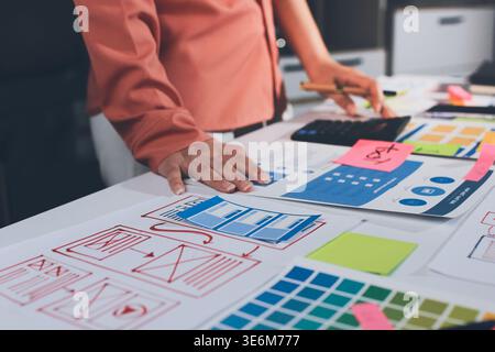 team of UI UX web designer are working together to develop mobile responsive websites with UI UX front end designer previews Stock Photo