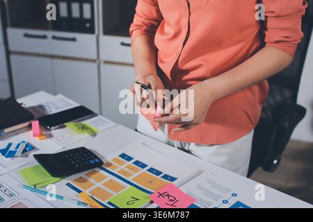 team of UI UX web designer are working together to develop mobile responsive websites with UI UX front end designer previews Stock Photo