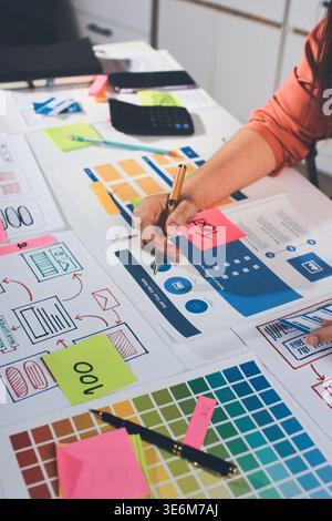 team of UI UX web designer are working together to develop mobile responsive websites with UI UX front end designer previews Stock Photo