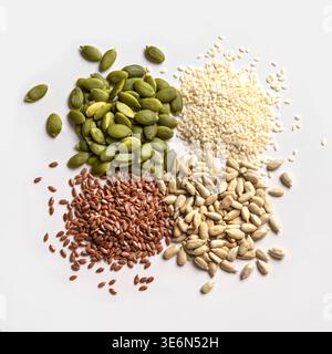 Pumpkin seeds, sesame, linseeds and sunflower seeds for making healthy seed mix. Healthy eating ingredient. Assortment of seeds on white background, Stock Photo