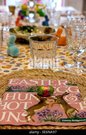 A table laid for an Easter lunch party with Easter Eggs and small bunny rabbits Stock Photo