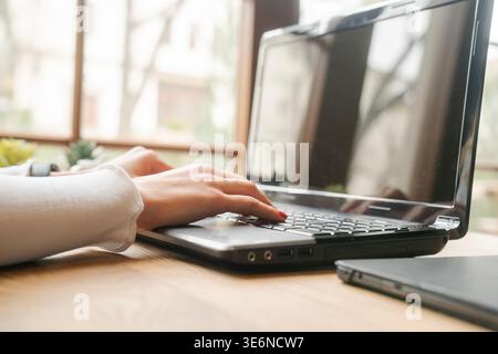 Minimalist desk setup with a laptop and natural lighting. Perfect for concepts like simplicity, modern workspaces, remote jobs, and productivity. Stock Photo