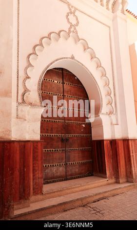 Traditional Moroccan arched wooden door in the Marrakech Medina Stock Photo