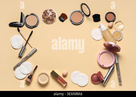 Frame made of cotton pads and different cosmetic products on beige background Stock Photo