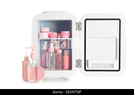 Small cosmetic refrigerator with cosmetic products on white background Stock Photo