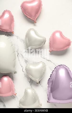Many heart shaped air balloons on white background. Valentine's day celebration Stock Photo