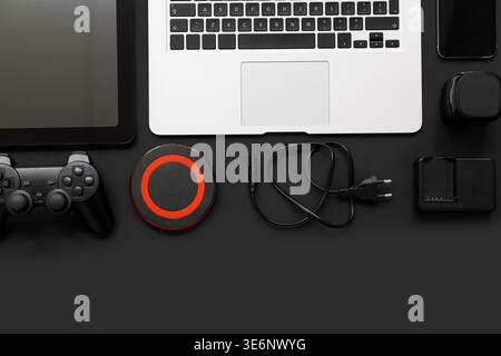 Composition with different modern gadgets on dark background Stock Photo