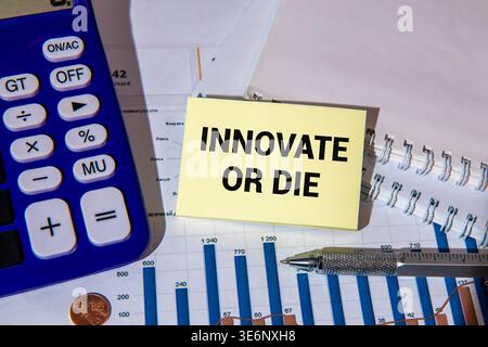 Concept of Innovate or die write on sticky notes isolated on Wooden Table. Stock Photo