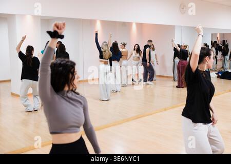 Diverse group of dancers practicing choreography in studio mirror Stock Photo