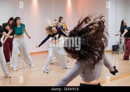 Group of dancers practicing dynamic choreography in studio Stock Photo